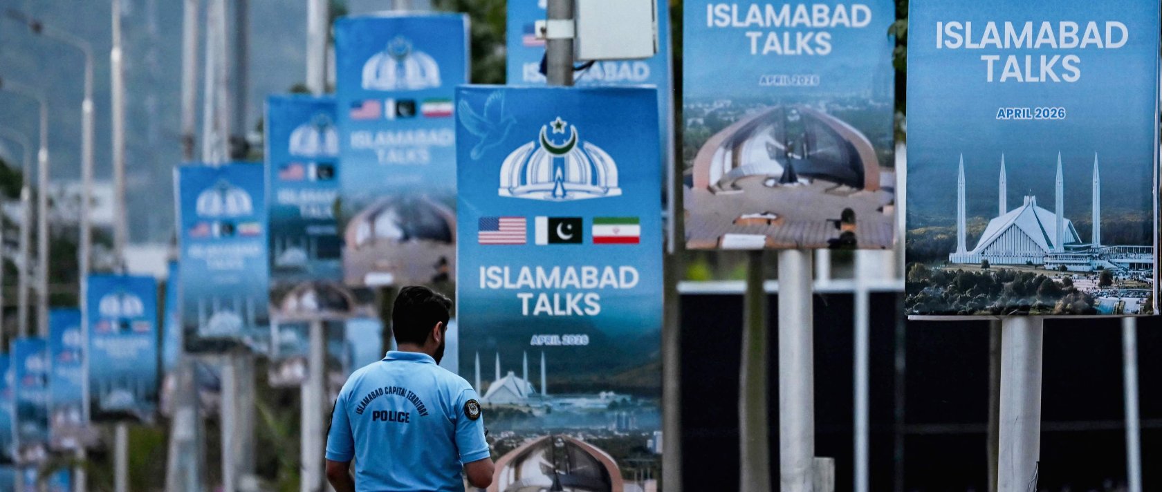 A policeman walks past posters highlighting Pakistan's mediation of Iran-U.S. peace talks, in Islamabad, Pakistan, April 18, 2026. (AFP Photo)