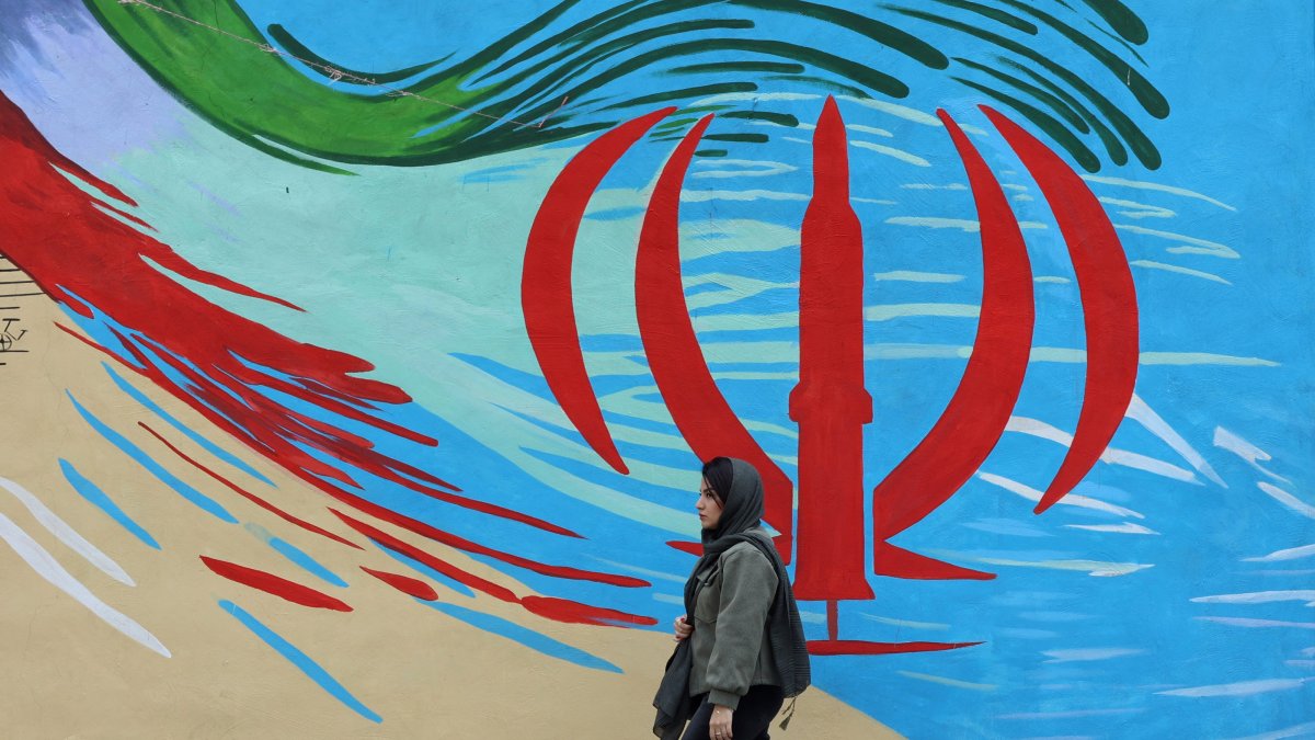 An Iranian woman walks next to a wall painting of Iran’s national flag on a street, Tehran, Iran, April 20, 2026. (EPA Photo)