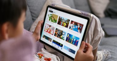 A 7-year-old boy looks at his iPad screen with the YouTube Kids app open, Sydney, Australia, Dec. 7, 2025. (Getty Images Photo)