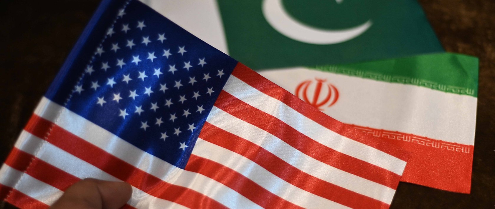 A shopkeeper displays Iranian, U.S. and Pakistani flags at a shop, Karachi, Pakistan, April 17, 2026. (EPA Photo)