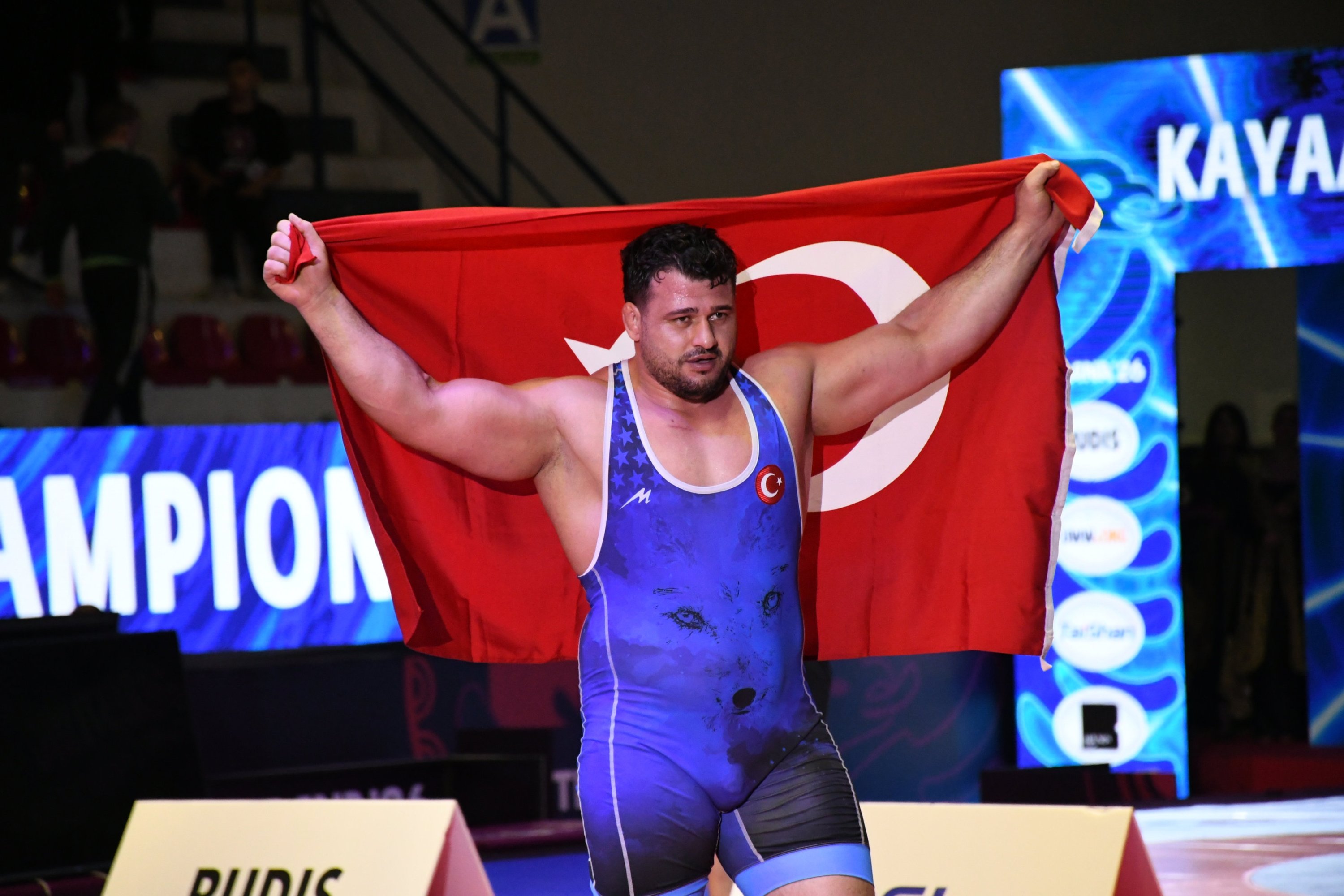 Rıza Kayaalp holds a Turkish flag after winning gold at the 2026 European Wrestling Championships in Tirana, Albania, April 22, 2026. (AA Photo)