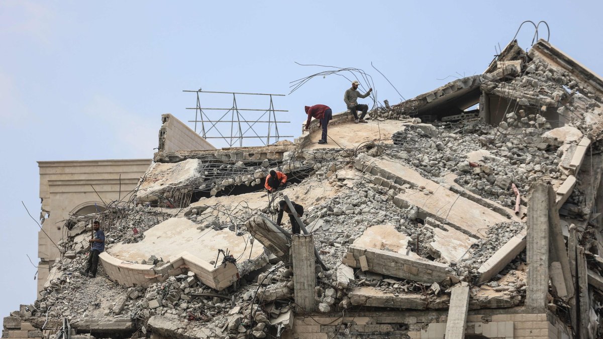 Palestinian men stand atop a heavily damaged building in Gaza City, central Gaza Strip, Palestine, April 20, 2026. (AFP Photo)