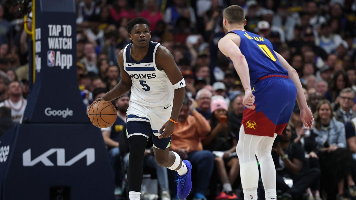 Timberwolves' Anthony Edwards (L) brings the ball down court against Nuggets' Christian Braun in NBA playoffs game, in Denver, Colorado, April 20, 2026. (AFP Photo)
