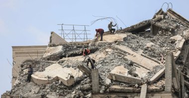 Palestinian men stand atop a heavily damaged building in Gaza City, central Gaza Strip, Palestine, April 20, 2026. (AFP Photo)