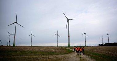 A group of people walk through a windpark, Feldheim, Germany, March 25, 2026. (AFP Photo)
