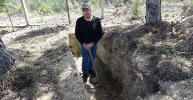 Miraç Erol (not a cat) stands inside the grave he dug for himself, Safranbolu, Türkiye, April 20, 2026. (IHA Photo)