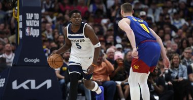 Timberwolves' Anthony Edwards (L) brings the ball down court against Nuggets' Christian Braun in NBA playoffs game, in Denver, Colorado, April 20, 2026. (AFP Photo)