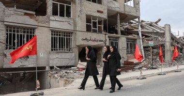 Iranian women walk past a residential building destroyed in a US-Israeli airstrike, in Tehran, Iran, April 13, 2026. (AFP Photo)