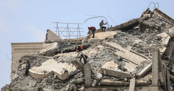 Palestinian men stand atop a heavily damaged building in Gaza City, central Gaza Strip, Palestine, April 20, 2026. (AFP Photo)