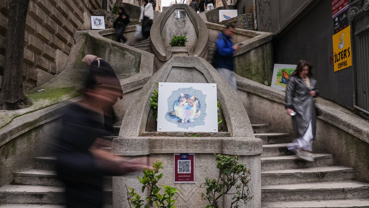 People walk past portraits designed by Ruken Adıbelli displayed on stairs, Istanbul, Türkiye, April 9, 2026. (AA Photo)