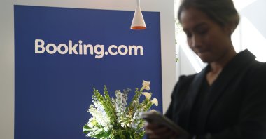 BERLIN, GERMANY - MARCH 04: A visitor uses a smartphone at the Booking.com stand at the 2026 ITB tourism trade fair, Berlin, Germany, March 4, 2026. (Getty Images Photo)