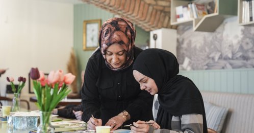 An instructor guides a young girl through a drawing exercise during a workshop, Istanbul, Türkiye, April 2, 2026. (AA Photo) 
