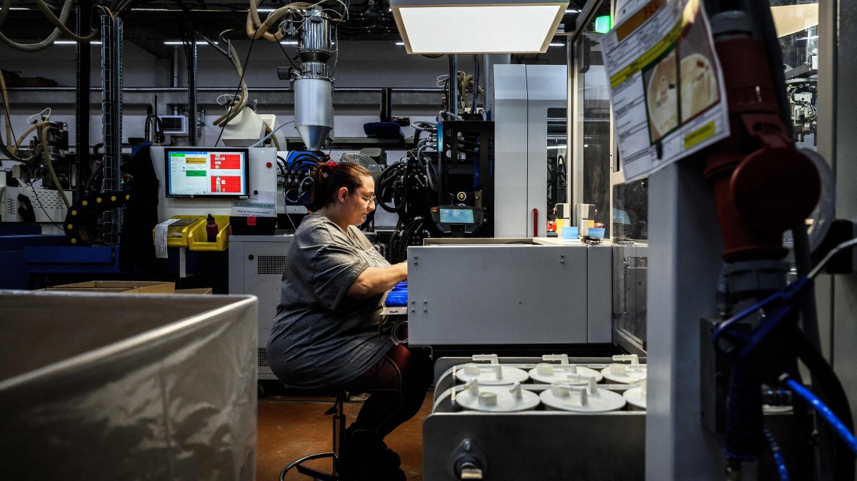 An employee producing plastic pieces in the Fancia factory, Bellignat, France, April 16, 2026. (AFP Photo)