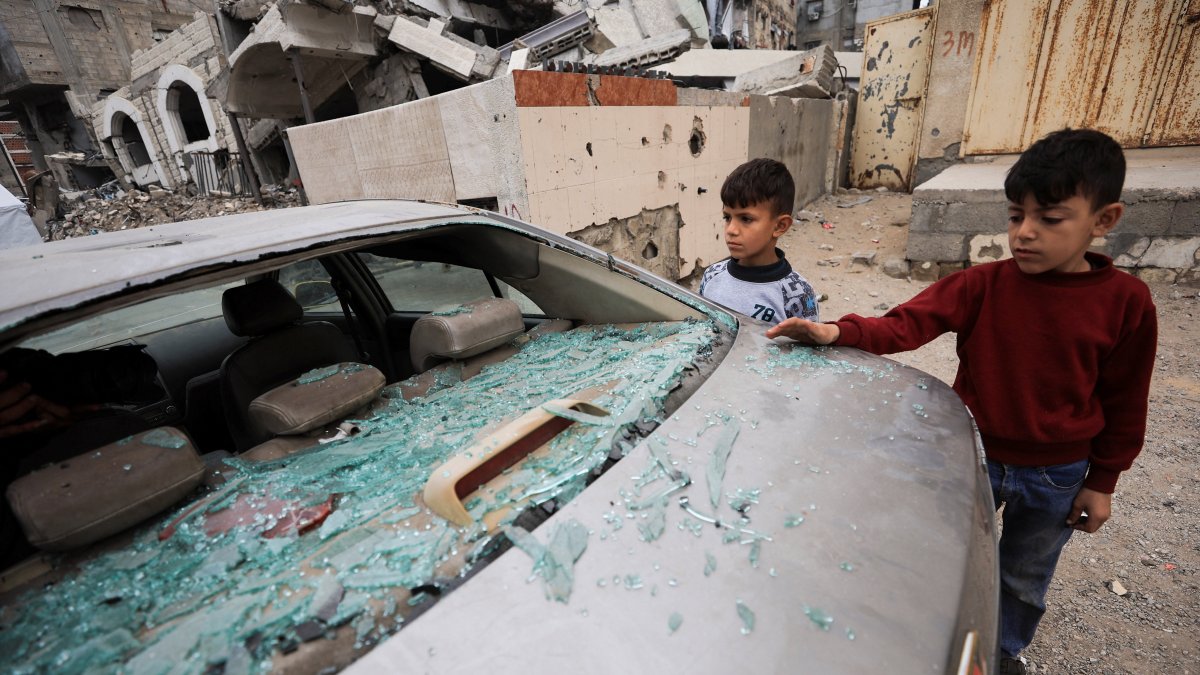 Palestinian children inspect a damaged car at the site of an Israeli strike that took place on Tuesday, at Al-Shati camp, in Gaza City, April 15, 2026. (Reuters Photo)