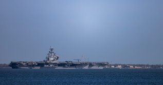 The USS George H.W. Bush (CVN 77) travels on the James River toward the Hampton Roads Bridge-Tunnel after departing from Naval Station Norfolk in Norfolk, Virginia, U.S., March 31, 2026. (AP Photo)