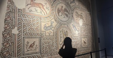 A visitor takes a photo of a mosaic at the Manisa Museum, Manisa, western Türkiye, April 16, 2026. (AA Photo)