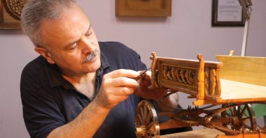 Turkish artist Pertev Aslan works on a scale model of a talika, an Ottoman-era horse-drawn carriage, Tekirdağ, Türkiye, March 8, 2026. (AA Photo)