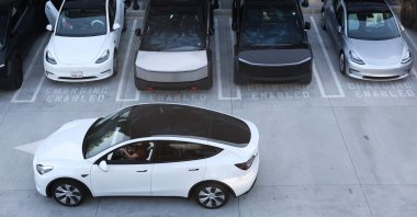 Tesla electric vehicles, including the Cybertruck, charge at stations during the opening of the Tesla Diner, Los Angeles, U.S., July 21, 2025. (AFP Photo)