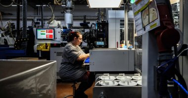 An employee producing plastic pieces in the Fancia factory, Bellignat, France, April 16, 2026. (AFP Photo)