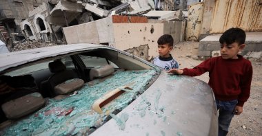Palestinian children inspect a damaged car at the site of an Israeli strike that took place on Tuesday, at Al-Shati camp, in Gaza City, April 15, 2026. (Reuters Photo)