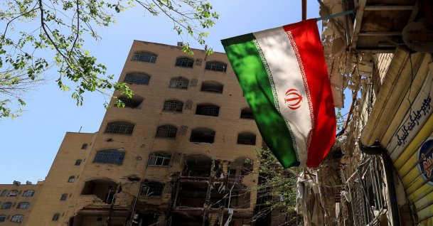 An Iranian flag flutters near a residential building damaged by a strike on March 4, in Tehran, Iran, April 14, 2026. (Reuters File Photo)