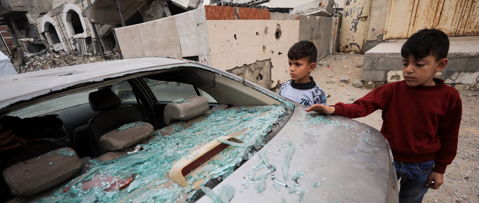 Palestinian children inspect a damaged car at the site of an Israeli strike that took place on Tuesday, at Al-Shati camp, in Gaza City, April 15, 2026. (Reuters Photo)