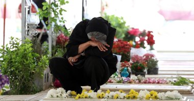 An Iranian woman mourns at the grave of a loved one killed during the U.S.-Israeli attacks at Behesht Zahra Cemetery, Tehran, Iran, April 23, 2026. (AFP Photo)