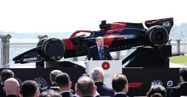 President Recep Tayyip Erdoğan speaks in front of a Formula 1 car as he officially announces the sport’s return to the country, Istanbul, Türkiye, April 24, 2026. (AA Photo)