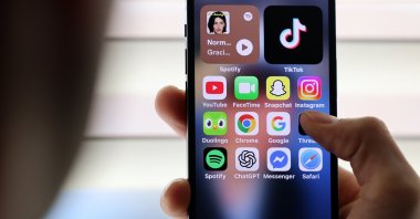 Social media apps are displayed on a handset, London, U.K., April 16, 2026. (EPA Photo)