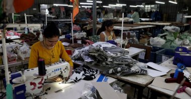 Employees stitch polyester fabric inside the readymade garment manufacturing department of Bindal Silk Mills in Surat, Gujarat, India, April 16, 2026. (Reuters Photo)