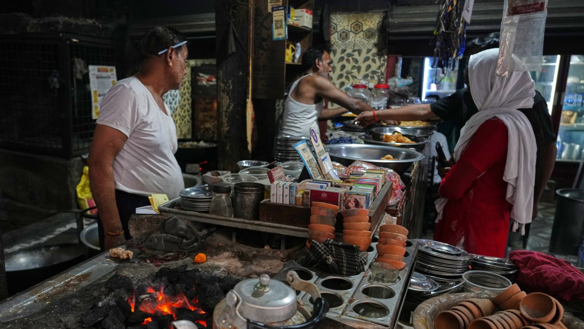 Workers cook over a coal fire at a small restaurant due to a shortage of commercial gas, Prayagraj, India, April 24, 2026. (AP Photo)