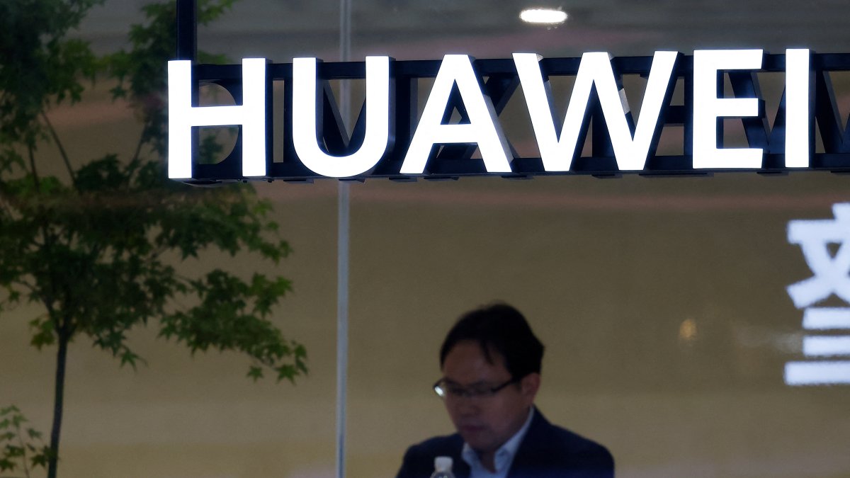 A man uses his smartphone at the Huawei booth at the Beijing International Automotive Exhibition (Auto China), Beijing, China, April 24, 2026. (Reuters Photo)
