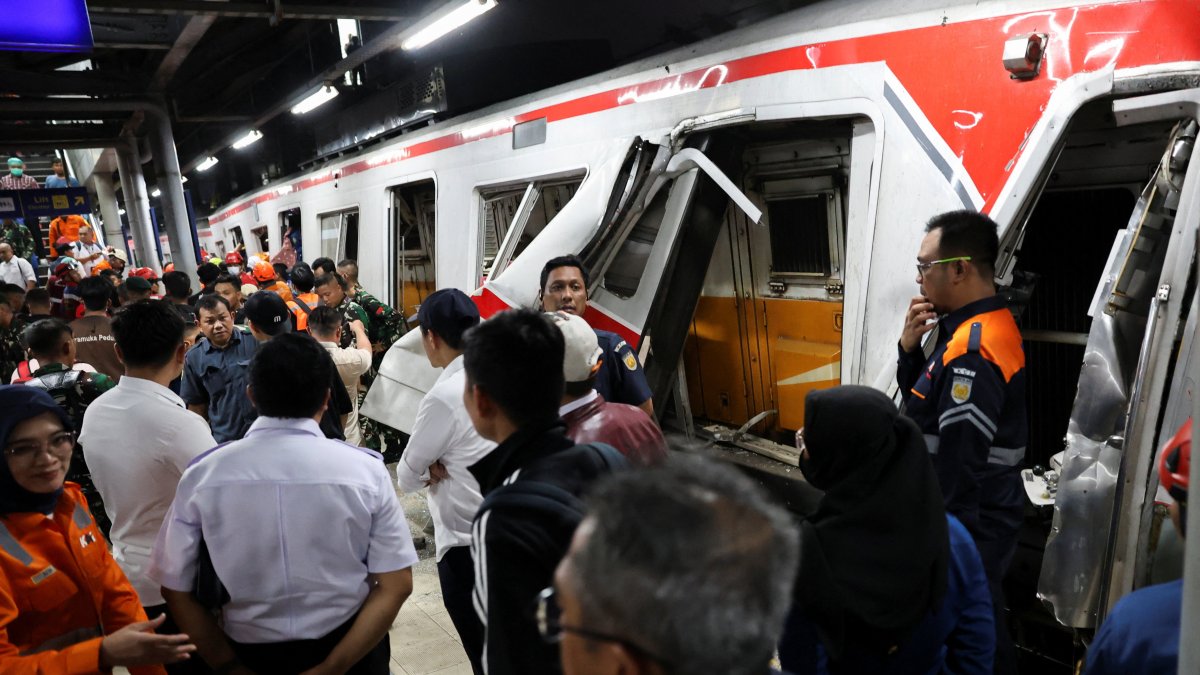 Workers stand near a damaged train after two trains collided in the city of Bekasi, West Java province, Indonesia, April 27, 2026. (Reuters Photo)