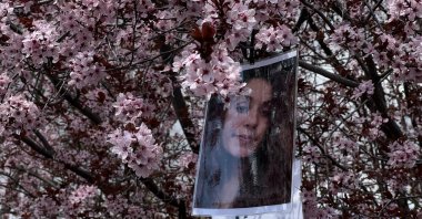 Gülistan Doku's photo hangs on tree branches during a gathering in Kışla Square, Tunceli, Türkiye, April 22, 2026. (AA Photo)