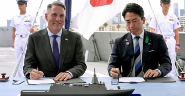 Australian Deputy Prime Minister and Minister for Defense Richard Marles (L) and Japan's Minister of Defense Koizumi Shinjiro sign the contract for Japan to deliver the first three of Mogami-class warships, part of a wider military buildup by Canberra aimed at boosting its long-range firepower to deter China, Melbourne, Australia, April 18, 2026. (AFP Photo)