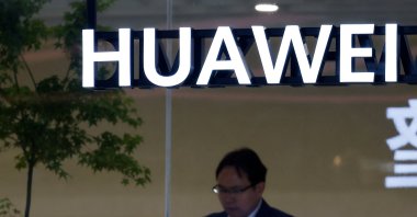 A man uses his smartphone at the Huawei booth at the Beijing International Automotive Exhibition (Auto China), Beijing, China, April 24, 2026. (Reuters Photo)