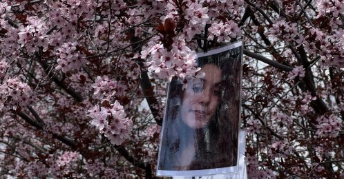 Gülistan Doku's photo hangs on tree branches during a gathering in Kışla Square, Tunceli, Türkiye, April 22, 2026. (AA Photo)