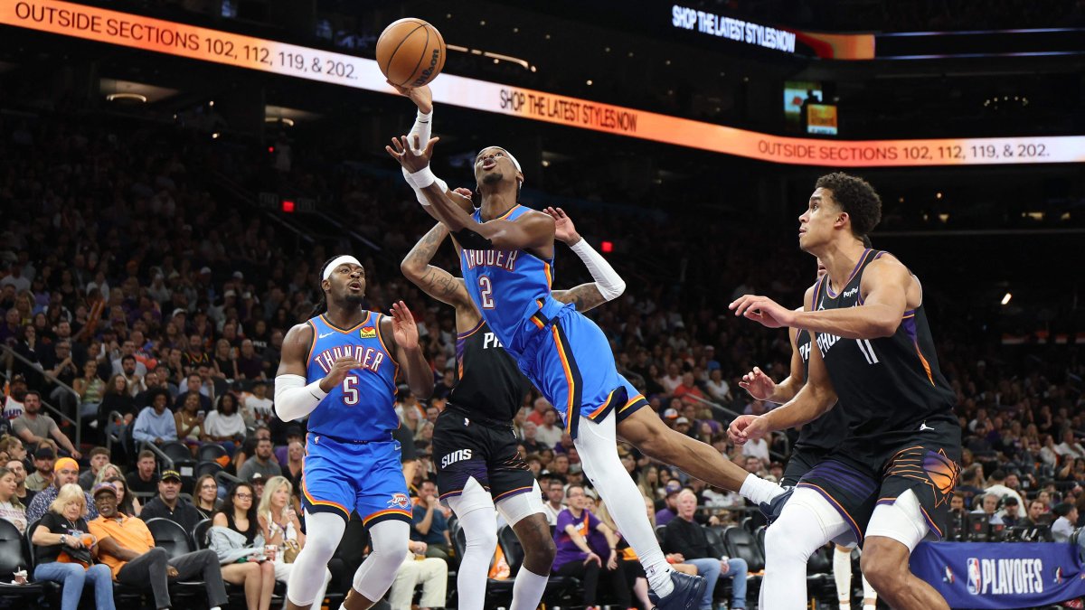 Thunder's Shai Gilgeous-Alexander shoots the ball between Suns' Jalen Green and Oso Ighodaro during an NBA Playoffs match in Phoenix, Arizona, U.S., April 27, 2026. (AFP Photo)