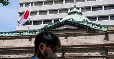 The Japanese national flag flutters in the wind on part of the Bank of Japan (BOJ) headquarters, Tokyo, Japan, April 28, 2026. (AFP Photo)
