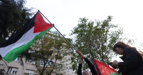 An activist waves a Palestinian flag during a protest outside the headquarters of public broadcaster RTS in Belgrade, Serbia, April 28, 2026. (EPA Photo)