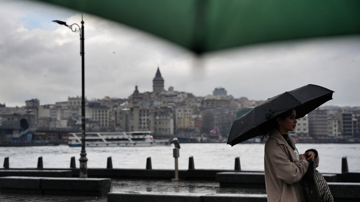 A person is seen walking with a backdrop of Galata Tower, Istanbul, Türkiye, April 10, 2026. (IHA Photo)