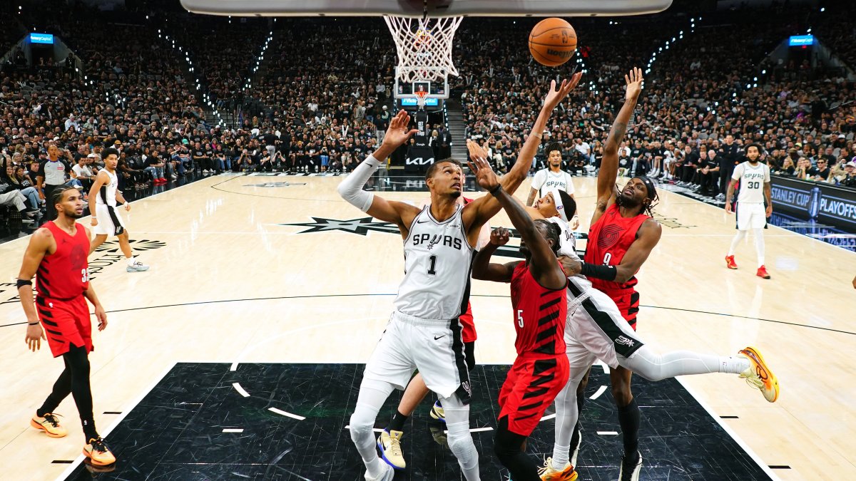 Spurs forward Victor Wembanyama (C) reaches for a rebound over Trail Blazers players during the second half of game five of the first round of the 2026 NBA Playoffs, San Antonio, Texas, U.S., April 28, 2026. (Reuters Photo)
