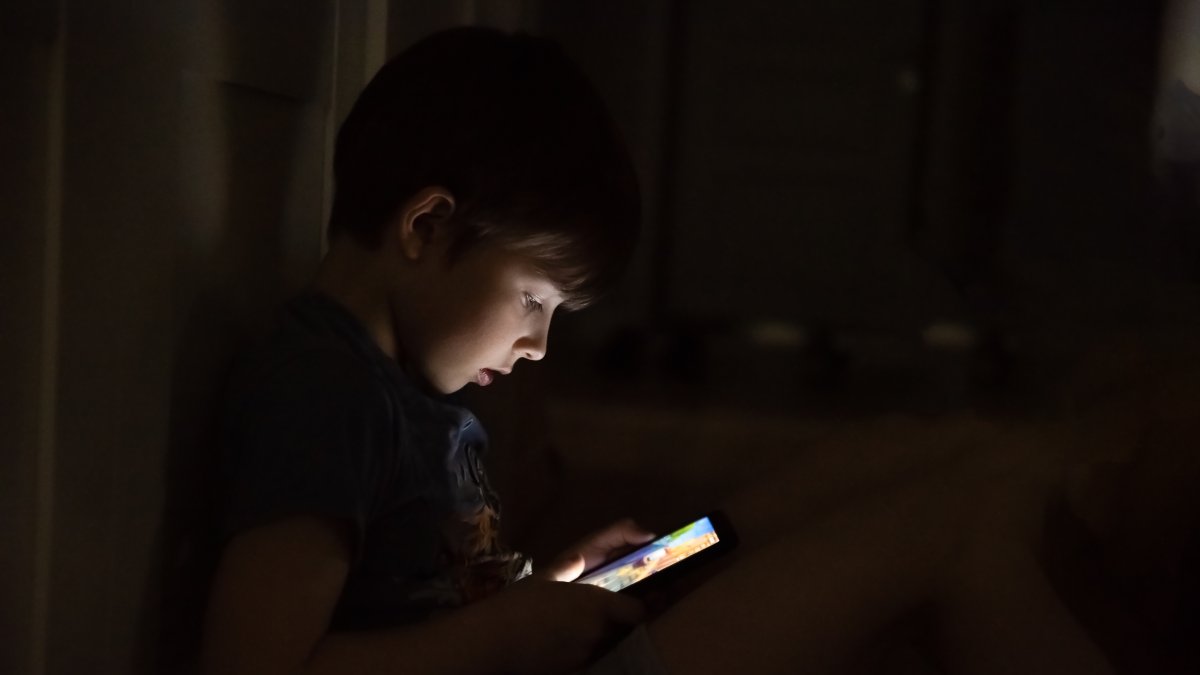 A child plays online games late at night. (Shutterstock Photo)