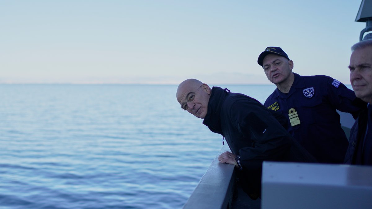 Greek Defense Minister Nikos Dendias looks at the sea as he attends a welcoming ceremony aboard the frigate Kimon, near Athens, Greece, Jan. 15, 2026. (AP Photo)