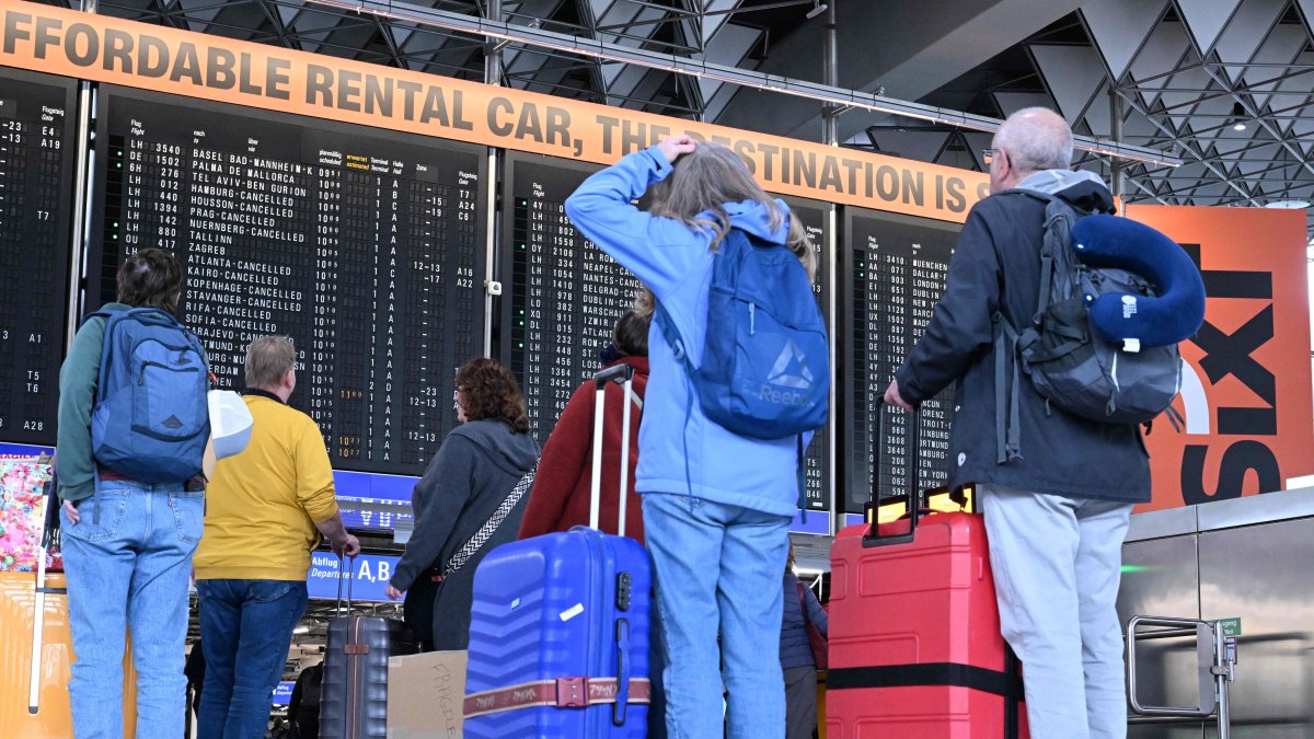 Passengers look at the announcement board showing canceled flights at Frankfurt Airport in Frankfurt am Main, Germany, April 10, 2026. (AFP Photo)