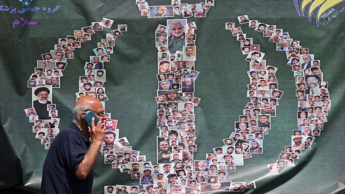 A man walks past a banner installed along the roadside in Tehran, Iran, April 29, 2026. (AFP Photo)