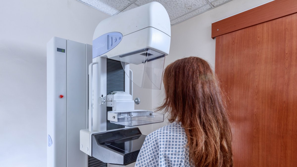 A patient undergoes a mammography examination using a medical imaging device for breast cancer screening. (Shutterstock Photo) 