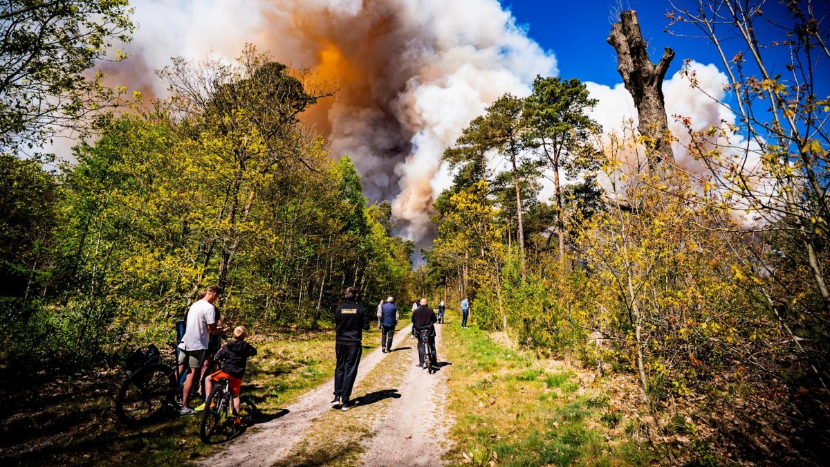 People watch a large wildfire burning on the shooting range at the training grounds between Epe and 't Harde, the Netherlands, April 29, 2026. (EPA Photo)
