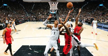 Spurs forward Victor Wembanyama (C) reaches for a rebound over Trail Blazers players during the second half of game five of the first round of the 2026 NBA Playoffs, San Antonio, Texas, U.S., April 28, 2026. (Reuters Photo)