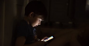 A child plays online games late at night. (Shutterstock Photo)